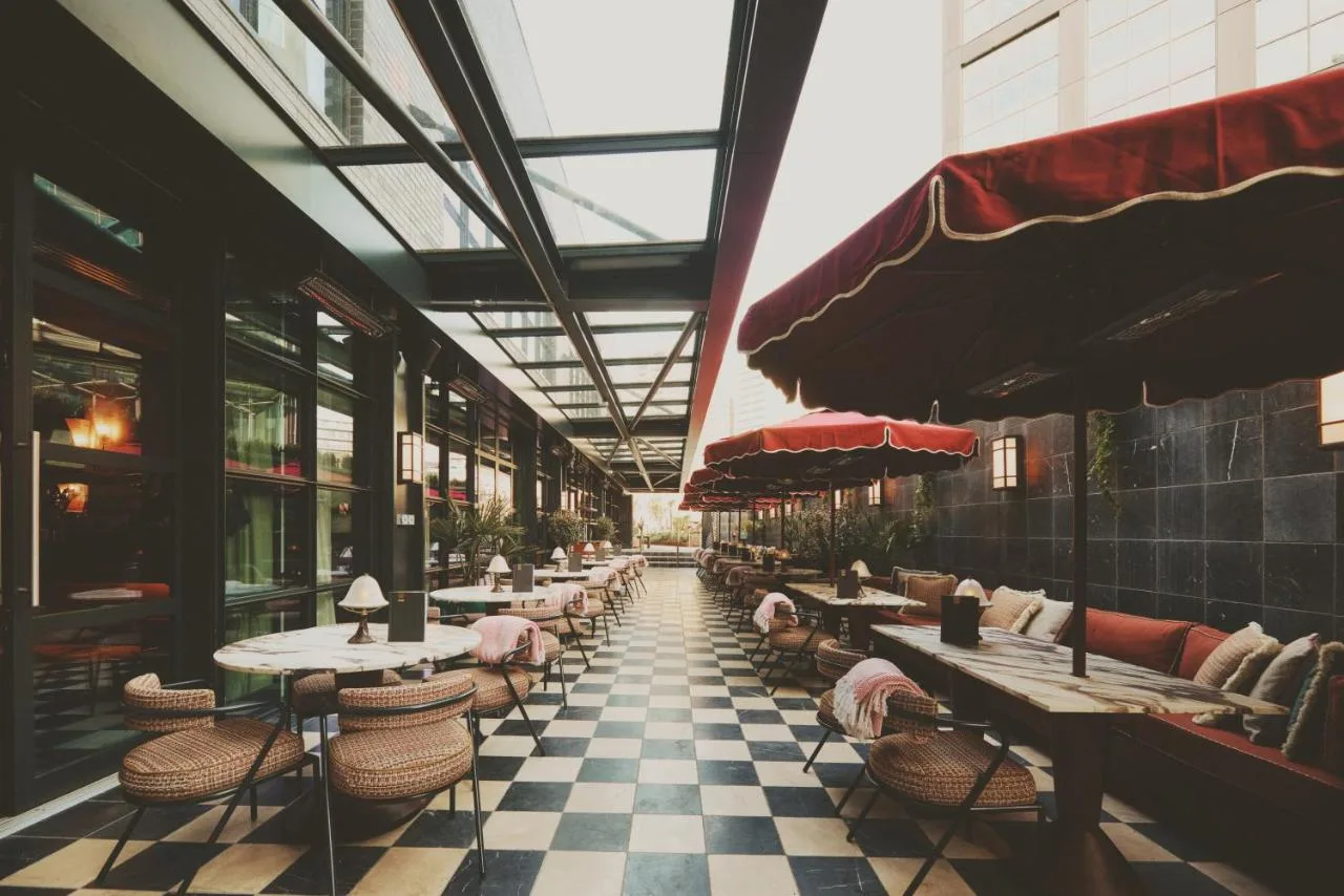 a restaurant with tables and chairs on a checkered floor at Mollie's Manchester in Manchester