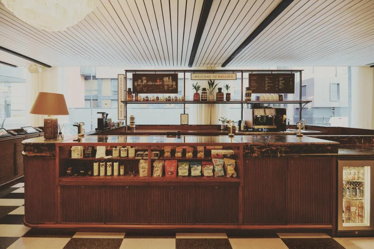 a bar in a room with a counter with alcohol at Mollie's Manchester in Manchester