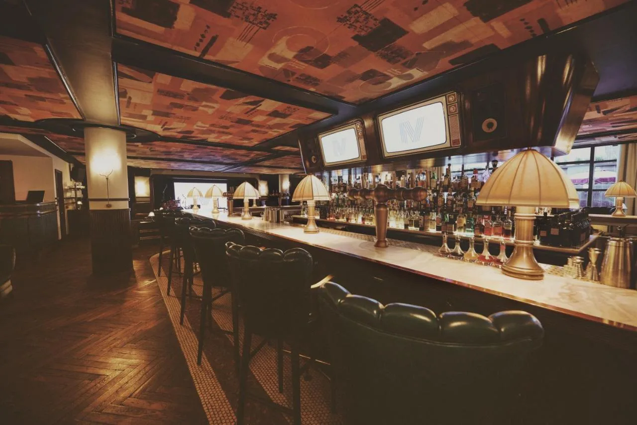 a bar with a row of chairs in a room at Mollie's Manchester in Manchester